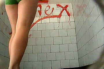 A brunette model goes to the pool bathroom to take a huge