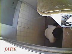 A horny Asian chick masturbating in the college toilet