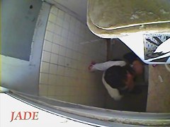 A horny Asian chick masturbating in the college toilet