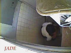 A horny Asian chick masturbating in the college toilet