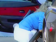Blonde MILF shows cleavage and ass at the carwash
