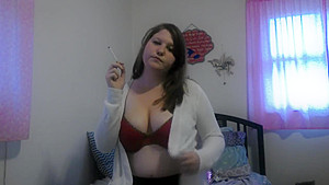Busty girl smokes and gives a peak