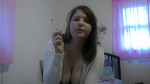 Busty girl smokes and gives a peak