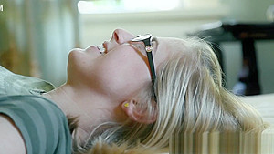 Busty lesbian in glasses fingers her pussy