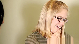 Busty lesbian in glasses fingers her pussy