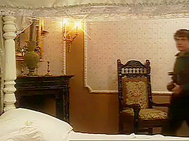 Erica Bella on a bed in black stockings