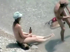 He covers her with sand for a blowjob