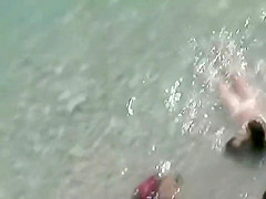 He covers her with sand for a blowjob