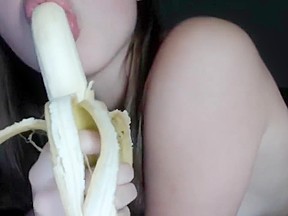 Horny young girl sucks banana