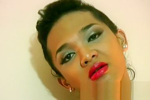 Ladyboy with big lips slips out of swimsuit and masturbates