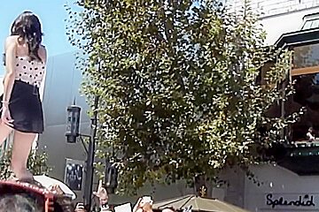 Man taking the peek of singing babe upskirt on his phone