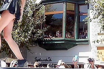 Man taking the peek of singing babe upskirt on his phone