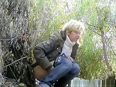 Mature caught pissing outdoors next to tree