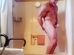 Mature stud takes a shower and cleans his dirty cock