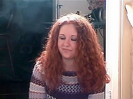 Smoking girl with lovely curly red hair