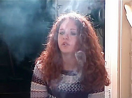 Smoking girl with lovely curly red hair