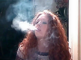 Smoking girl with lovely curly red hair