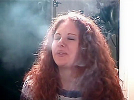 Smoking girl with lovely curly red hair