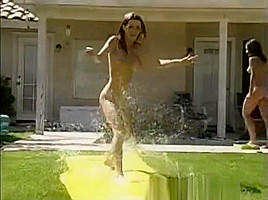Tawnee Stone sliding fun in the garden with friends