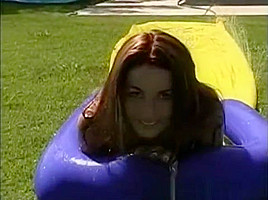Tawnee Stone sliding fun in the garden with friends