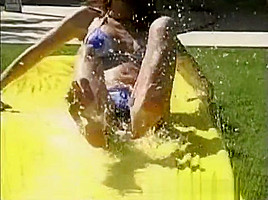 Tawnee Stone sliding fun in the garden with friends