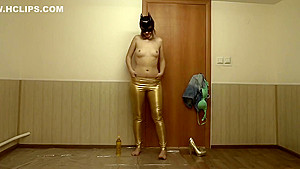 The girl removes gold leggings, smeared with oil and masturbates