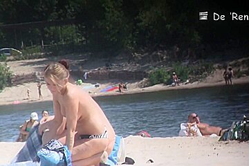 Two blondies are having a good time on the beach with naked boobs