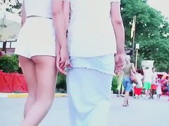 Two lesbian babes are walking around in white shorts