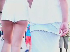 Two lesbian babes are walking around in white shorts