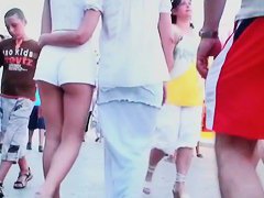 Two lesbian babes are walking around in white shorts