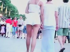 Two lesbian babes are walking around in white shorts