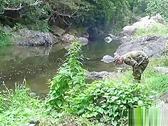 Two military lads resting by the river