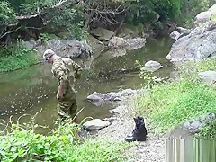 Two military lads resting by the river