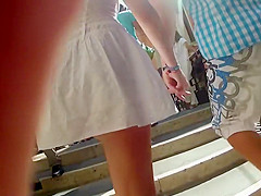 Upskirt of a girl holding hands with a guy