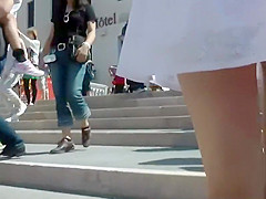 Upskirt of a girl holding hands with a guy