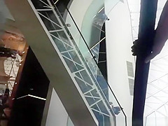 Upskirted in the shopping mall rolling stairs