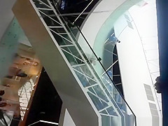 Upskirted in the shopping mall rolling stairs