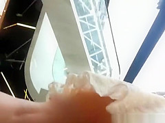 Upskirted in the shopping mall rolling stairs