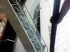 Upskirted in the shopping mall rolling stairs