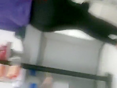 Woman in black leggings in supermarket