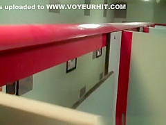 Woman in red jacket pissing