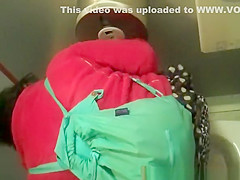 Woman in red jacket pissing