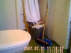 Woman taking a seat in toilet and peeing