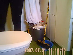 Woman taking a seat in toilet and peeing